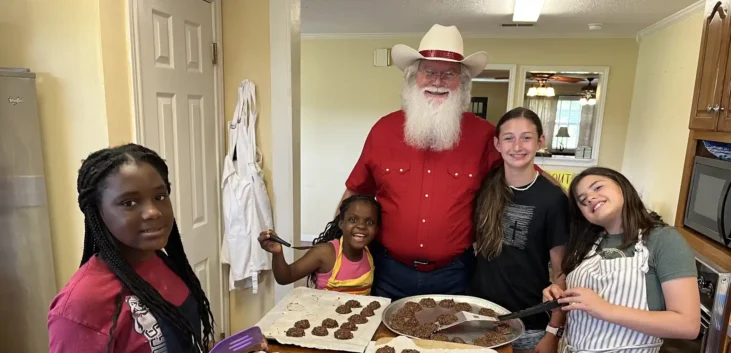 Cowboy Santa baking treats with the kids